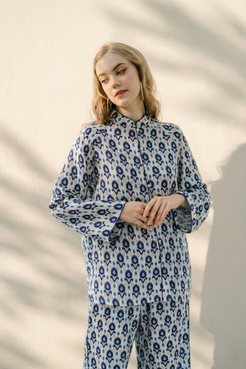 Woman wearing Bunbun patterned pajama set with blue and white design.