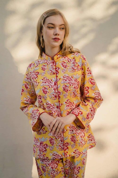 Woman wearing colorful floral Bunbun pajama set outdoors.