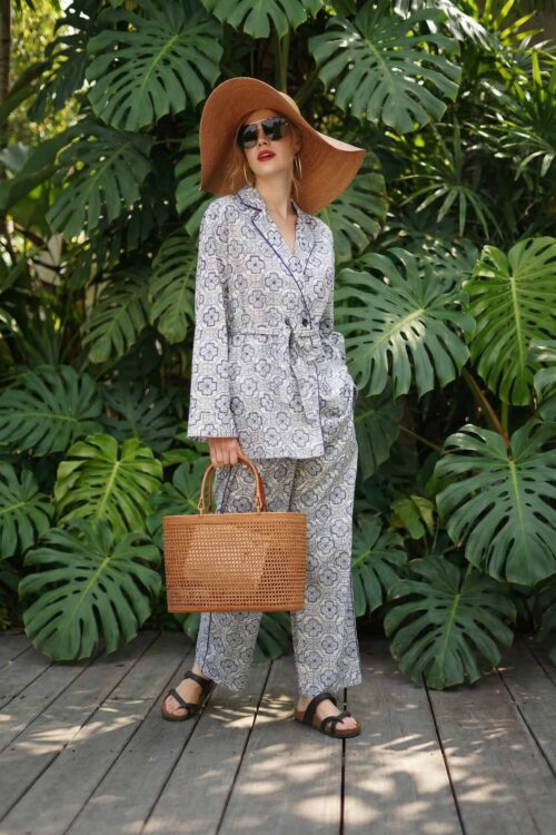 Elegant linen suit with a wide-brim hat, perfect for a stylish and tidy summer look.