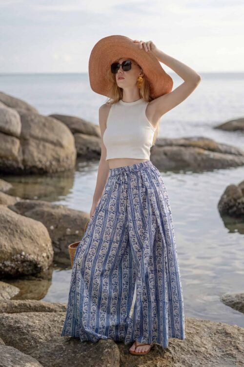 Woman wearing stylish Waya Away trousers by the seaside.