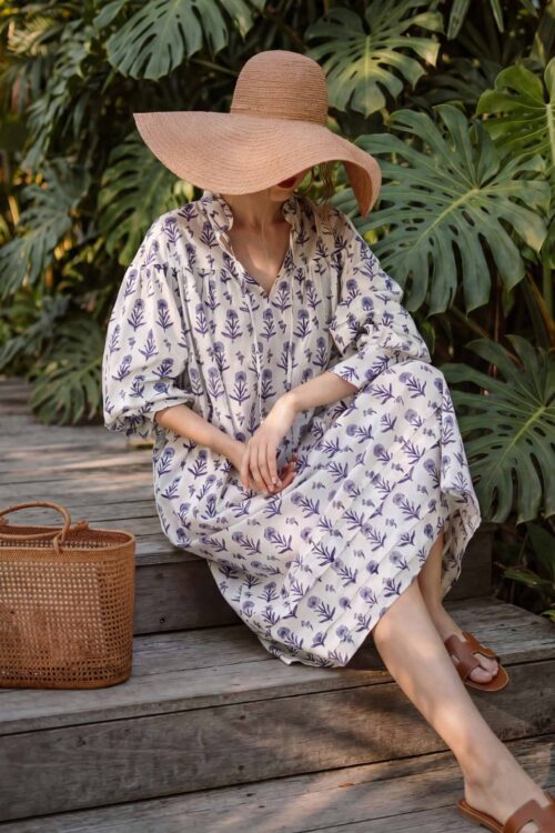 Brim straw hat and floral dress perfect for all-year outdoor fashion.
