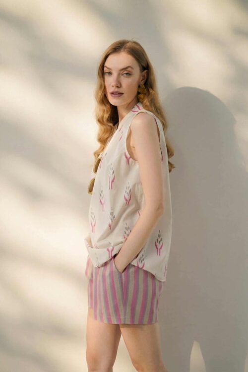 Elegant woman wearing honey-colored outfit with a relaxed pose.