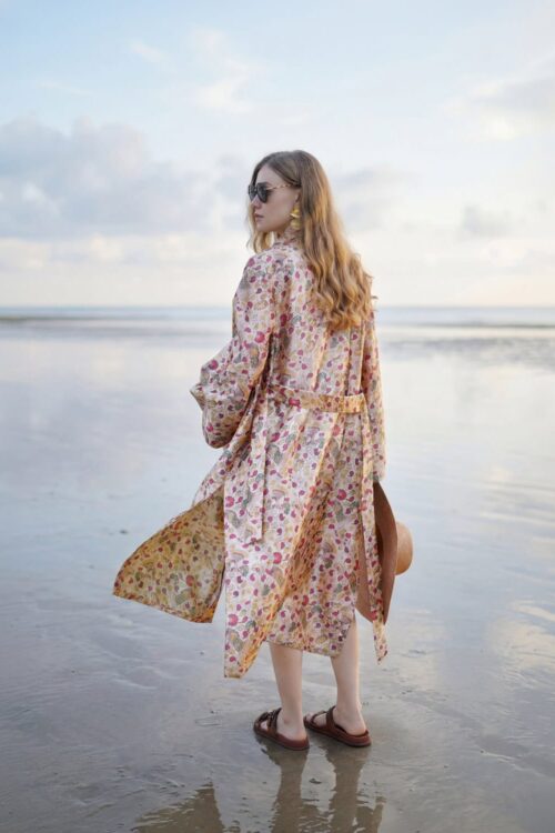 Beachwear dress with floral pattern and flowy design.