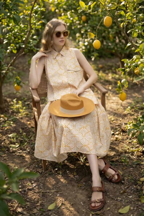 Lemon orchard scene with a woman relaxing among lemon trees, embodying love and tranquility.