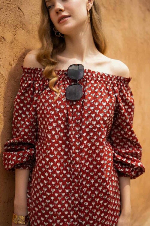 Shoulder red dress with white floral print, perfect for casual or summer wear. Features elastic neck.